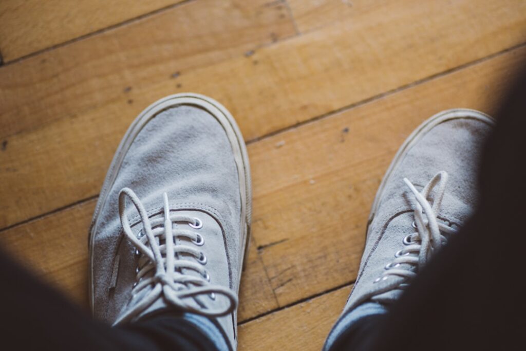A person standing on top of a wooden floor