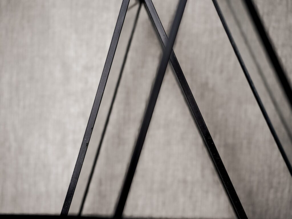 Black metal frame creates geometric shapes.