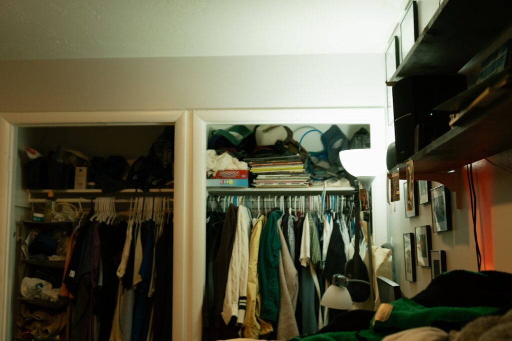 Closets overflowing with clothes and other items.