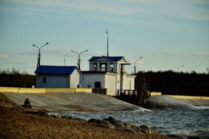 A building stands beside flowing water.