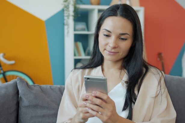 A woman looking at her smartphone on a couch.