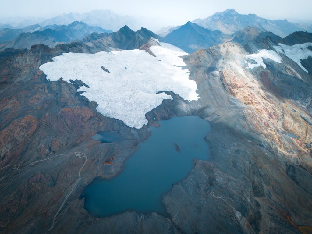An aerial view of a snow covered mountain range