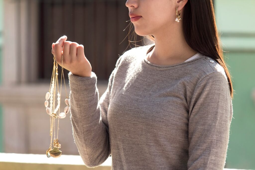 woman in gray long sleeve shirt holding gold trophy