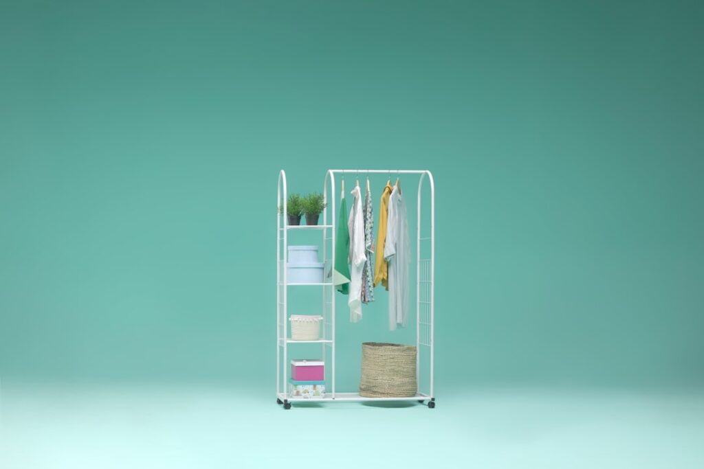 a rack with clothes and a hat on it