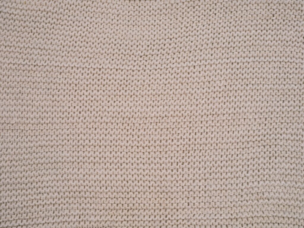a close up of a white knitted material