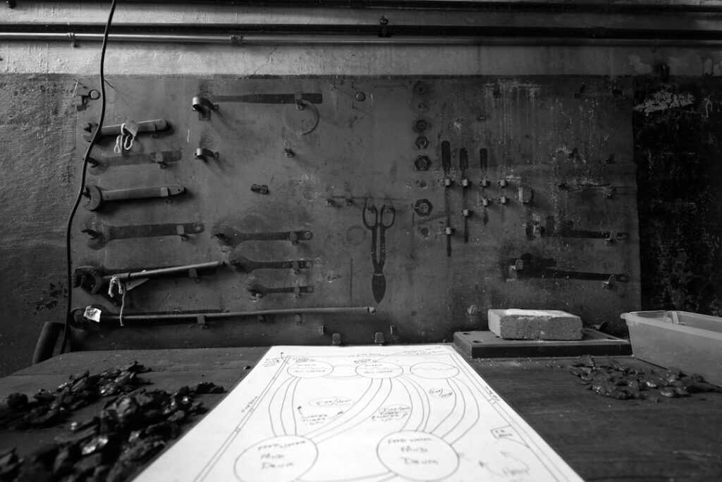 Tools arranged on a wall above a workbench