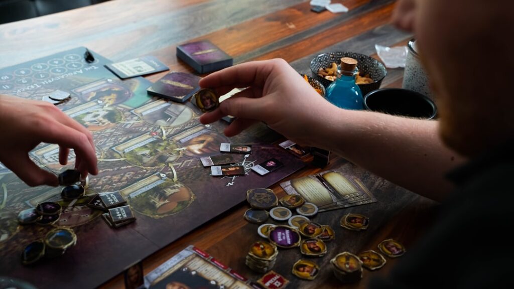 two people playing a board game on a table