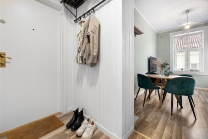 A room with a coat rack and a table