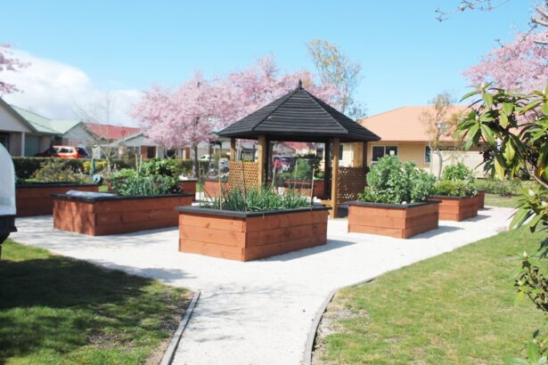 Raised garden beds surround a gazebo in a park.