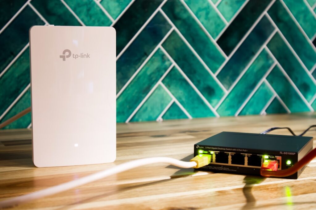 A wi-fi router and a network switch sit side-by-side.