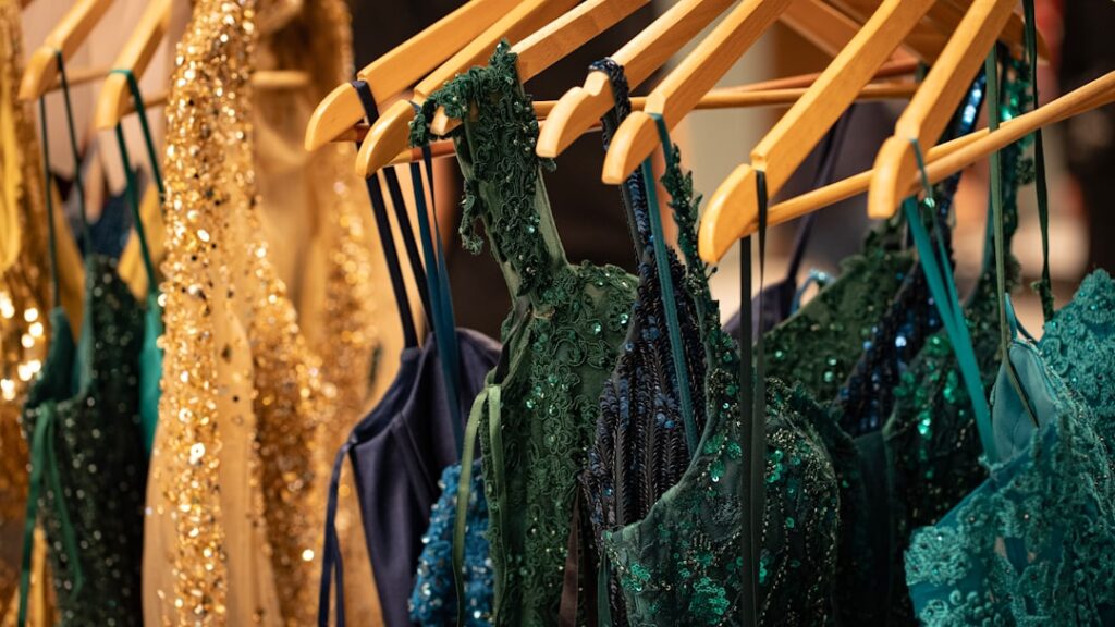 Sparkling dresses are hanging on a clothes rack.
