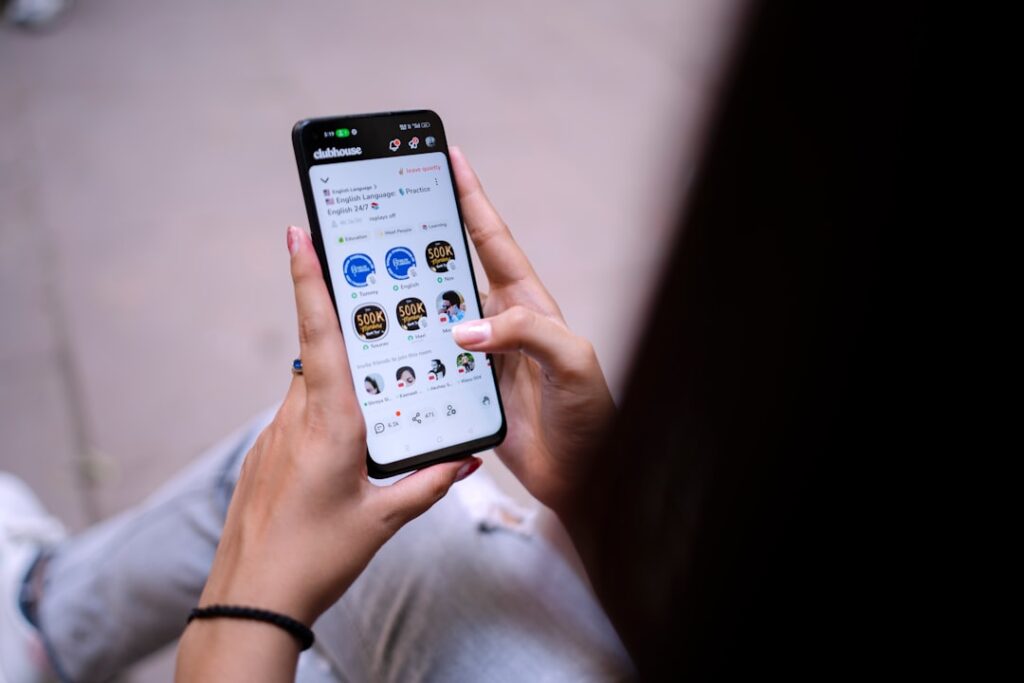 a person holding a cell phone in their hand