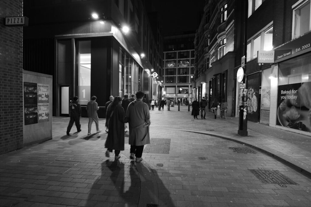 People walking down a city street at night
