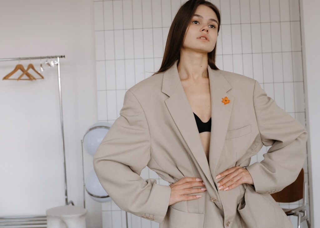 A woman poses in an oversized blazer.