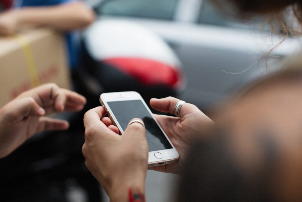 a woman holding a smart phone in her hands
