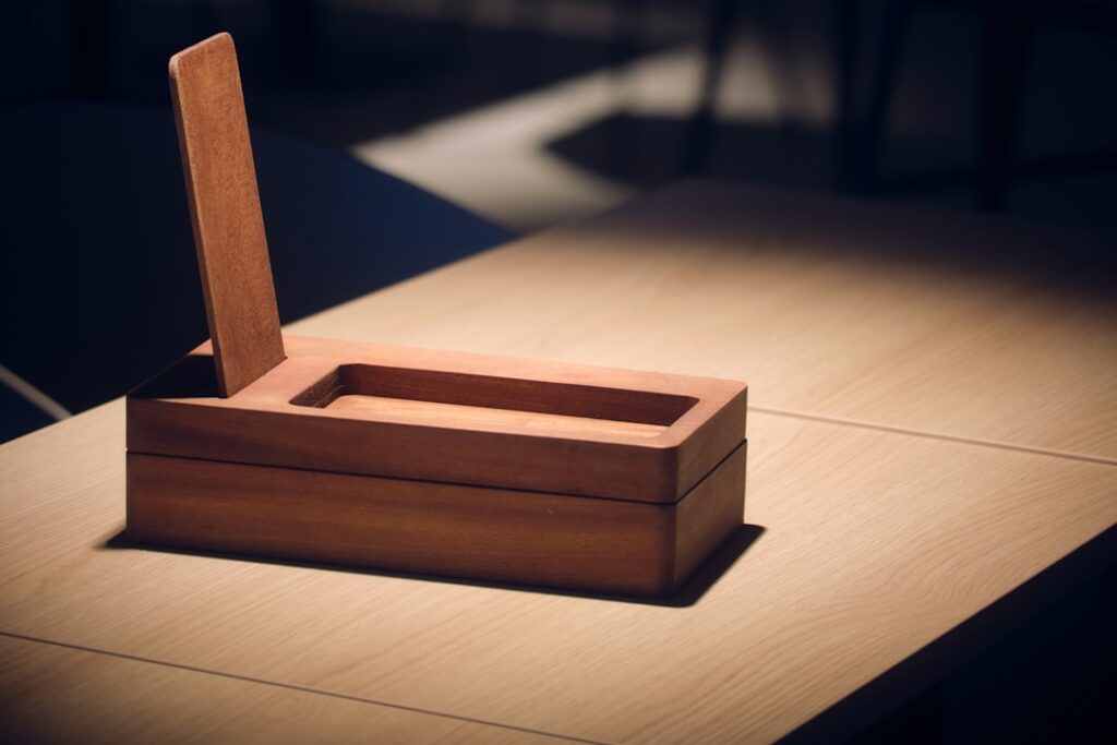 A wooden box with an open lid on a table