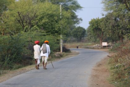 Two men walking on a rural road
