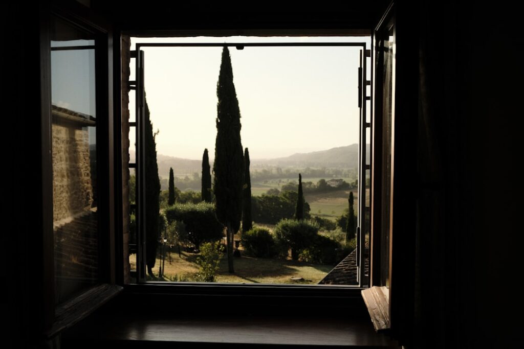 View of tuscan landscape through an open window