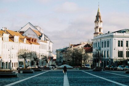 Wide plaza with historic buildings and a clock tower.