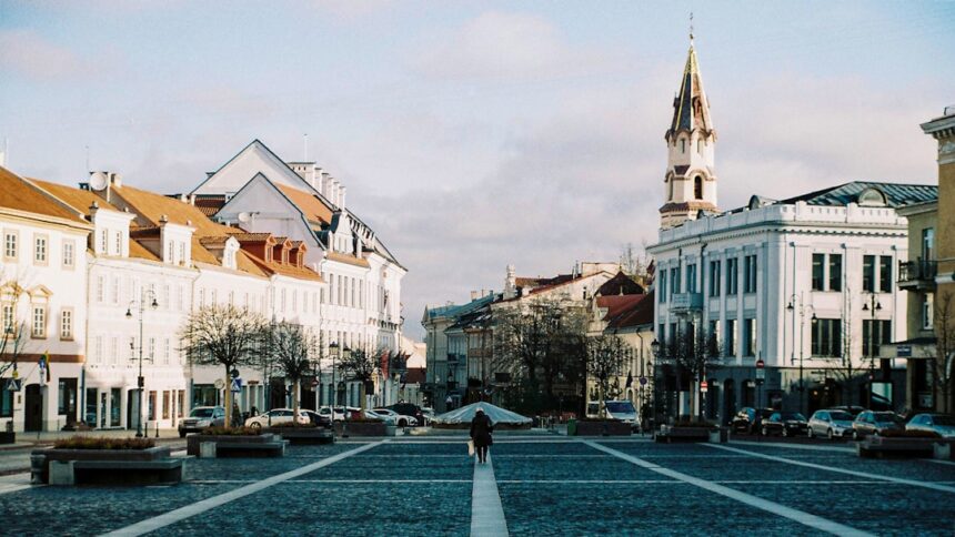 Wide plaza with historic buildings and a clock tower.