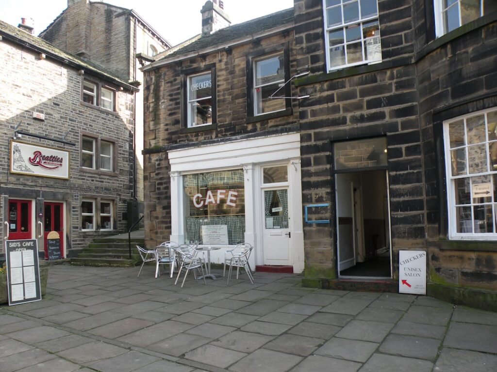 Cafe with outdoor seating on cobblestone street