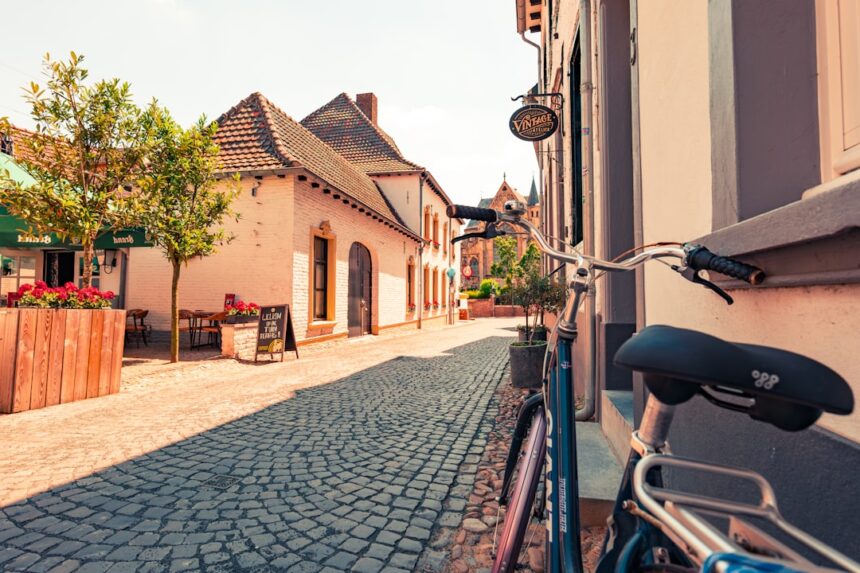 Bicycle parked on a cobblestone street in a european town.