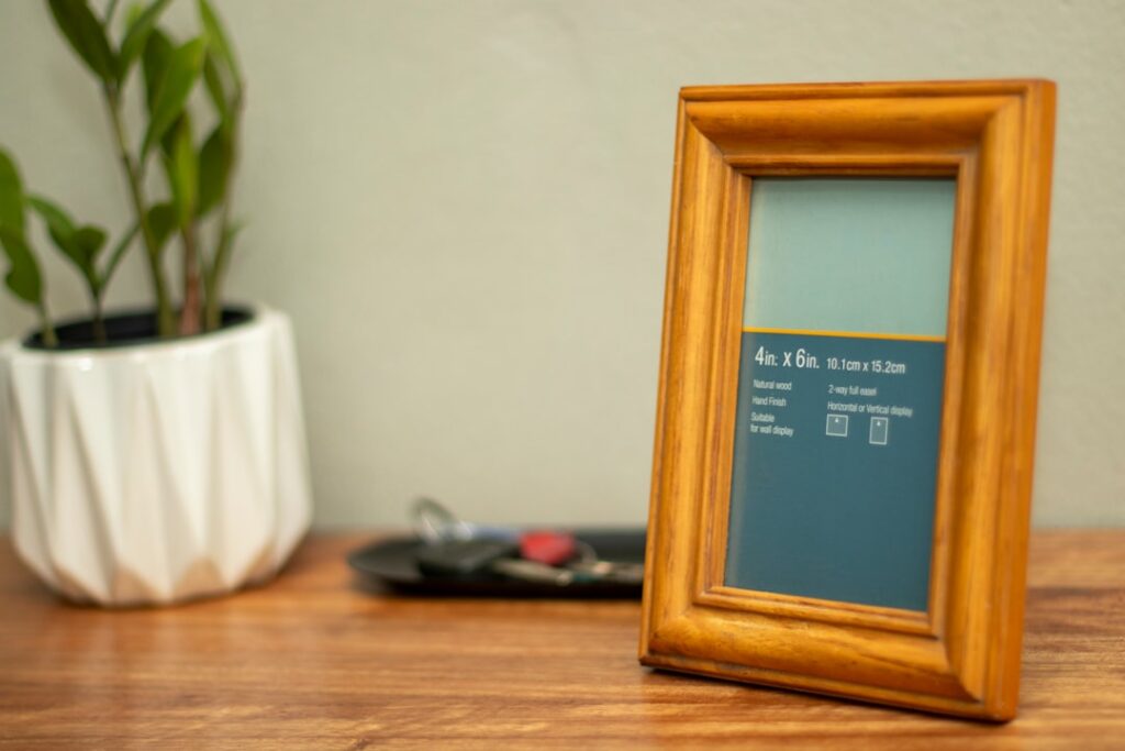 Empty wooden frame on a wooden table.