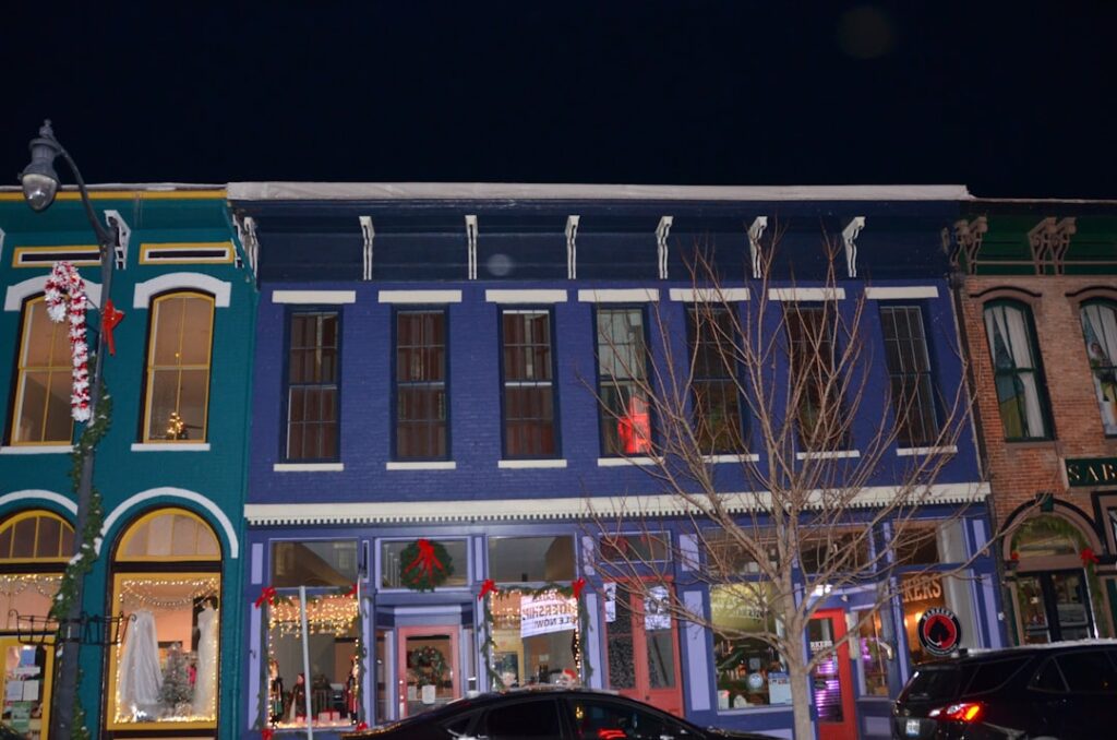 Colorful buildings on a street at night.