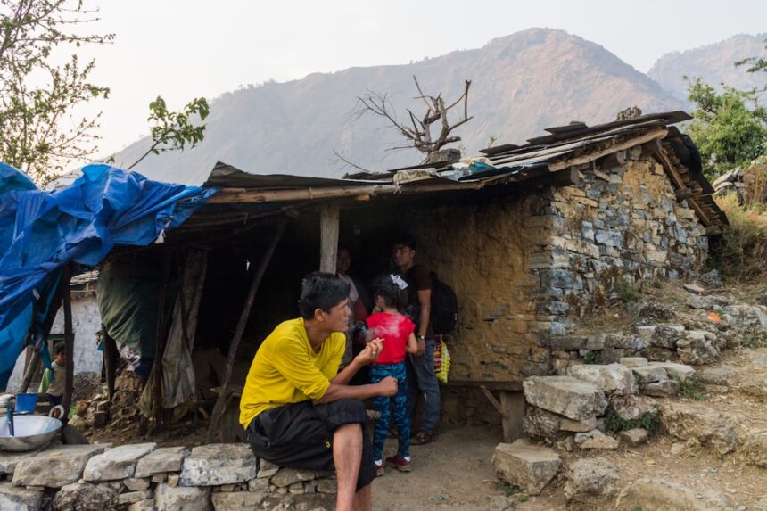 Family gathered outside a rustic mountain dwelling