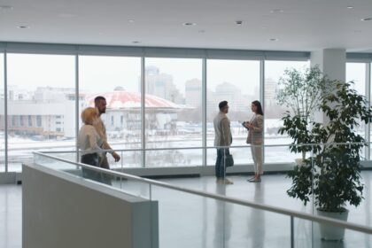 People in a modern office lobby with large windows