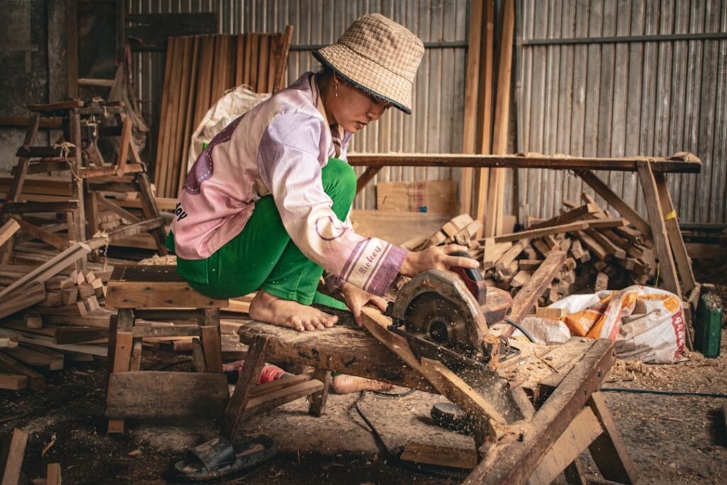 Woman using a saw in a workshop