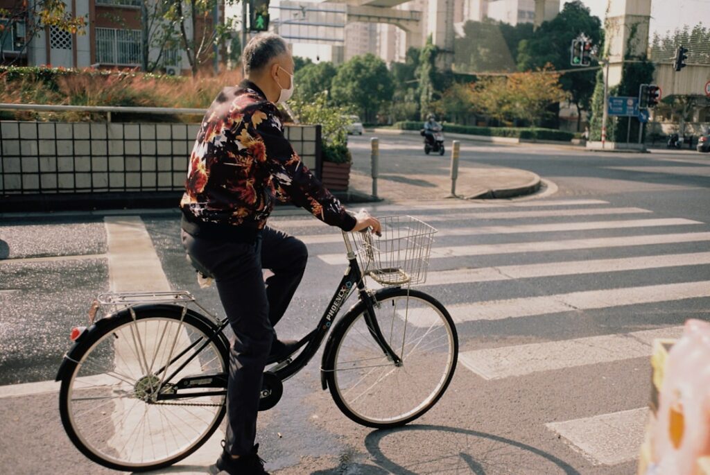 a man riding a bike down a street