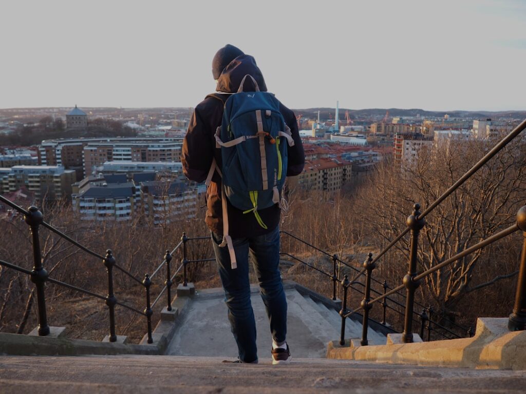 a person with a backpack walking up some stairs