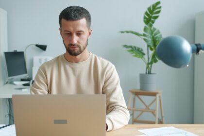 Man working on a laptop at a desk.