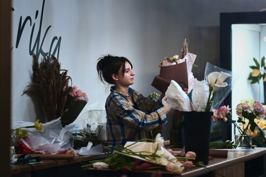 a woman arranging flowers in a flower shop