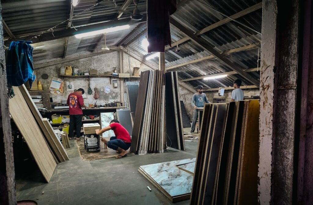 Workers in a workshop with wooden boards