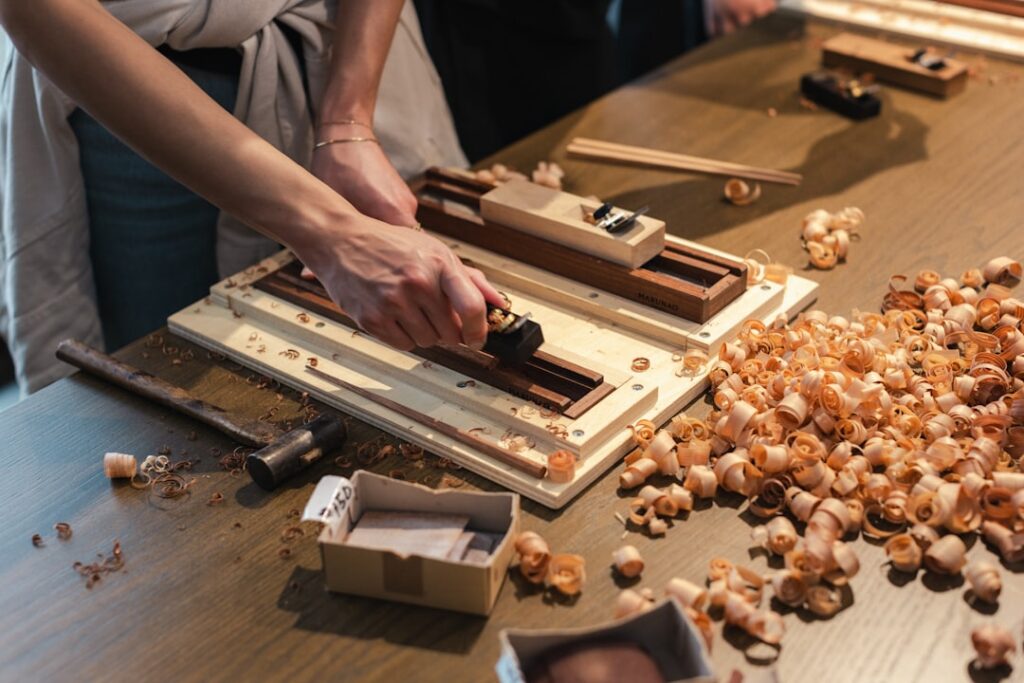 A group of people standing around a wooden table
