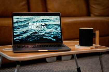 a laptop computer sitting on top of a wooden table