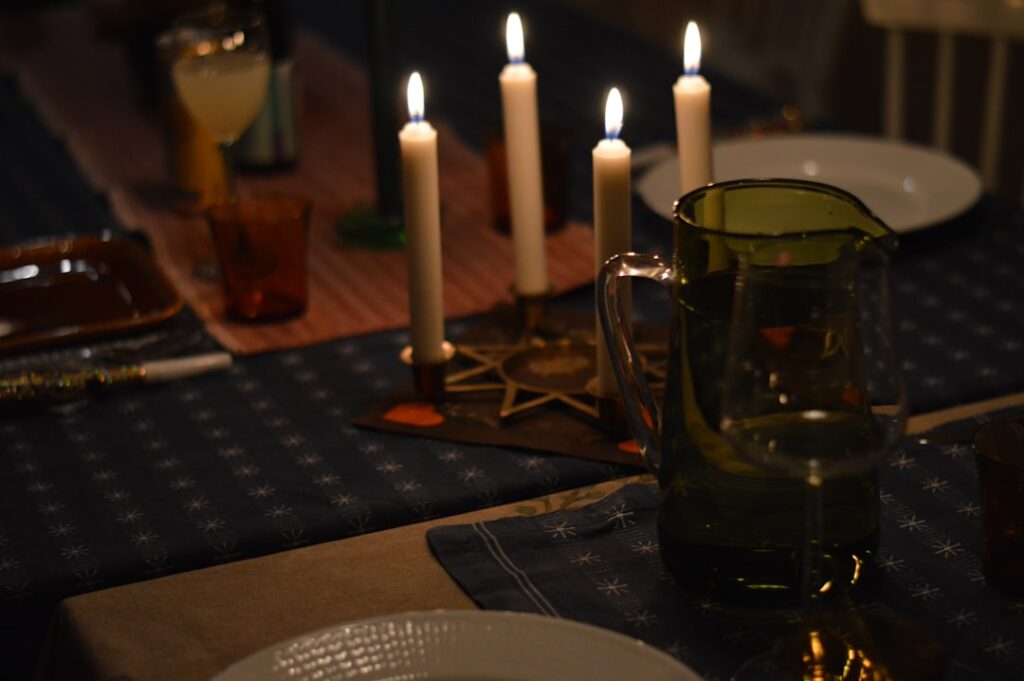 Candles lit on a dinner table setting