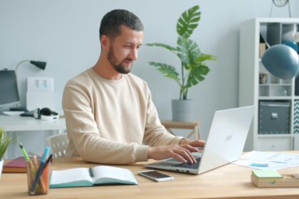 Man typing on laptop at a desk