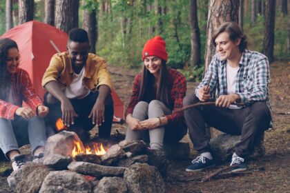 Friends gathered around a campfire in the woods