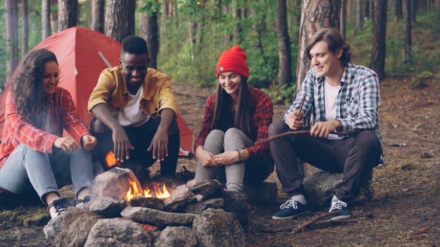 Friends gathered around a campfire in the woods