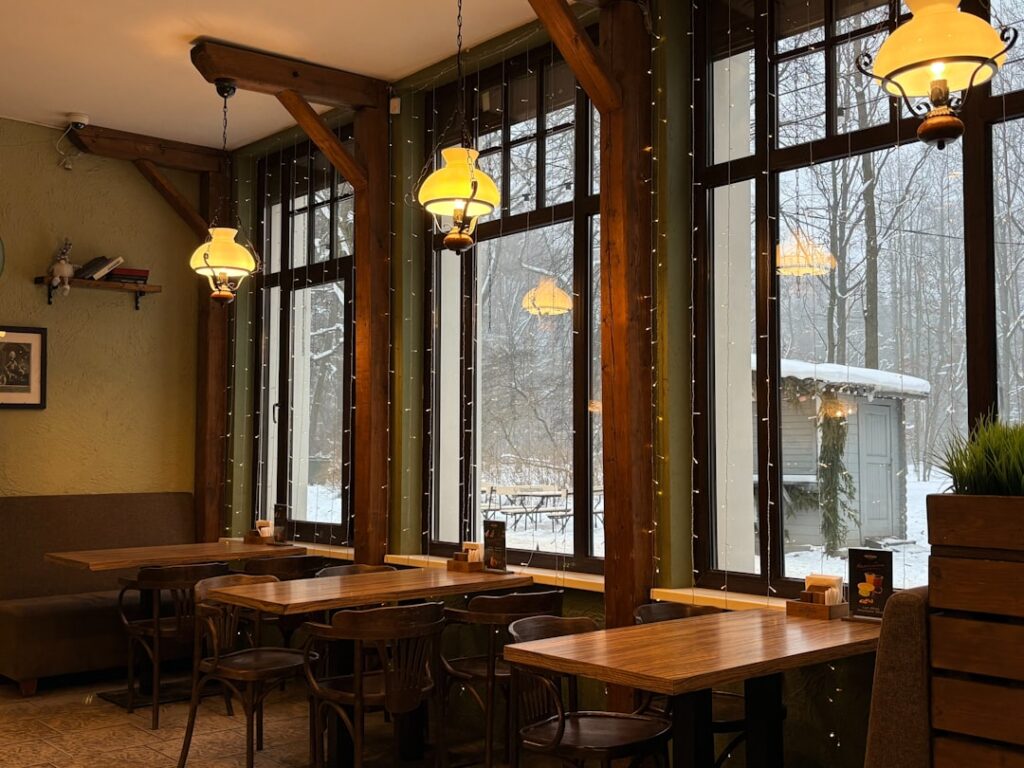 Cozy cafe interior with wooden tables and chairs