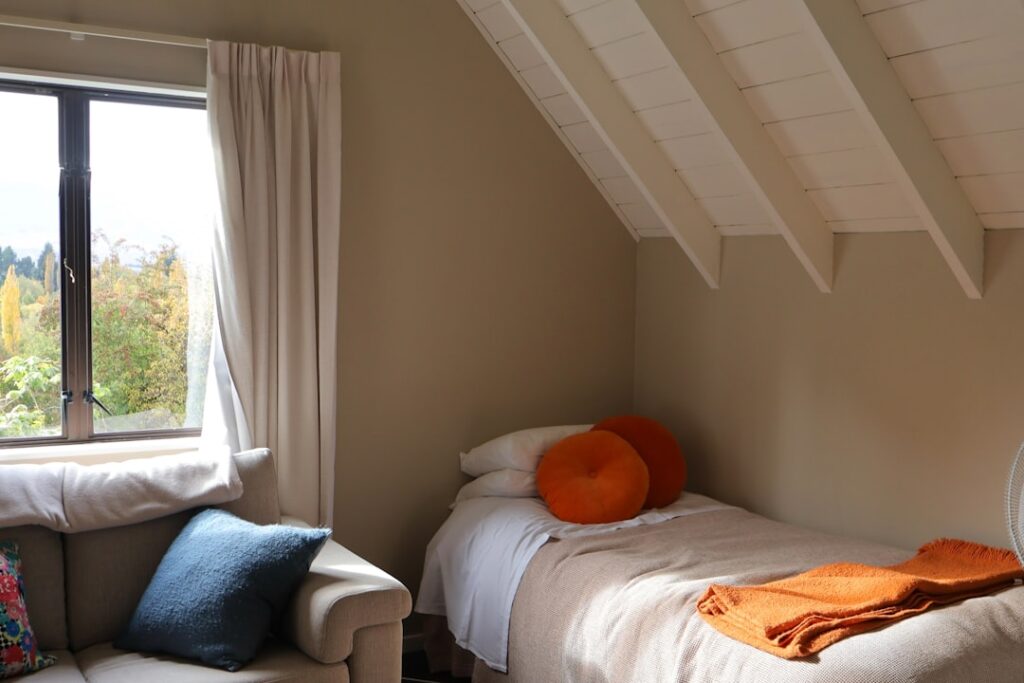 Cozy bedroom with a single bed and window view.