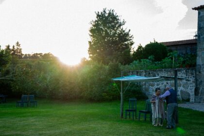 Couple embracing in a garden at sunset