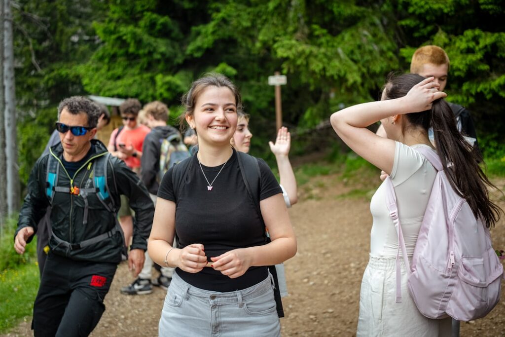 Group of hikers walking on a forest trail