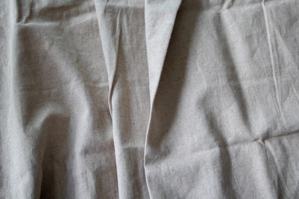 A close up of a bed with a white sheet