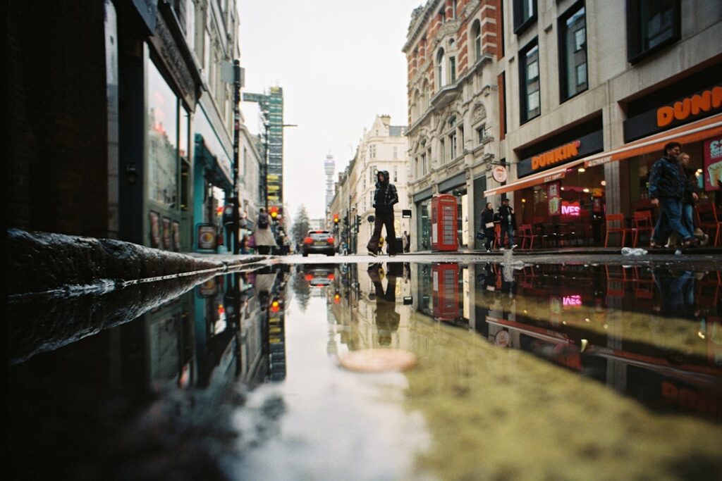 City street with reflections in puddles after rain