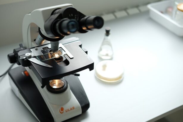 A microscope sitting on top of a table next to a bottle