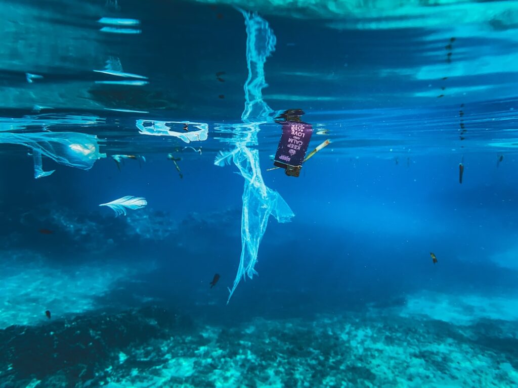 Plastic waste floating in the clear blue ocean water